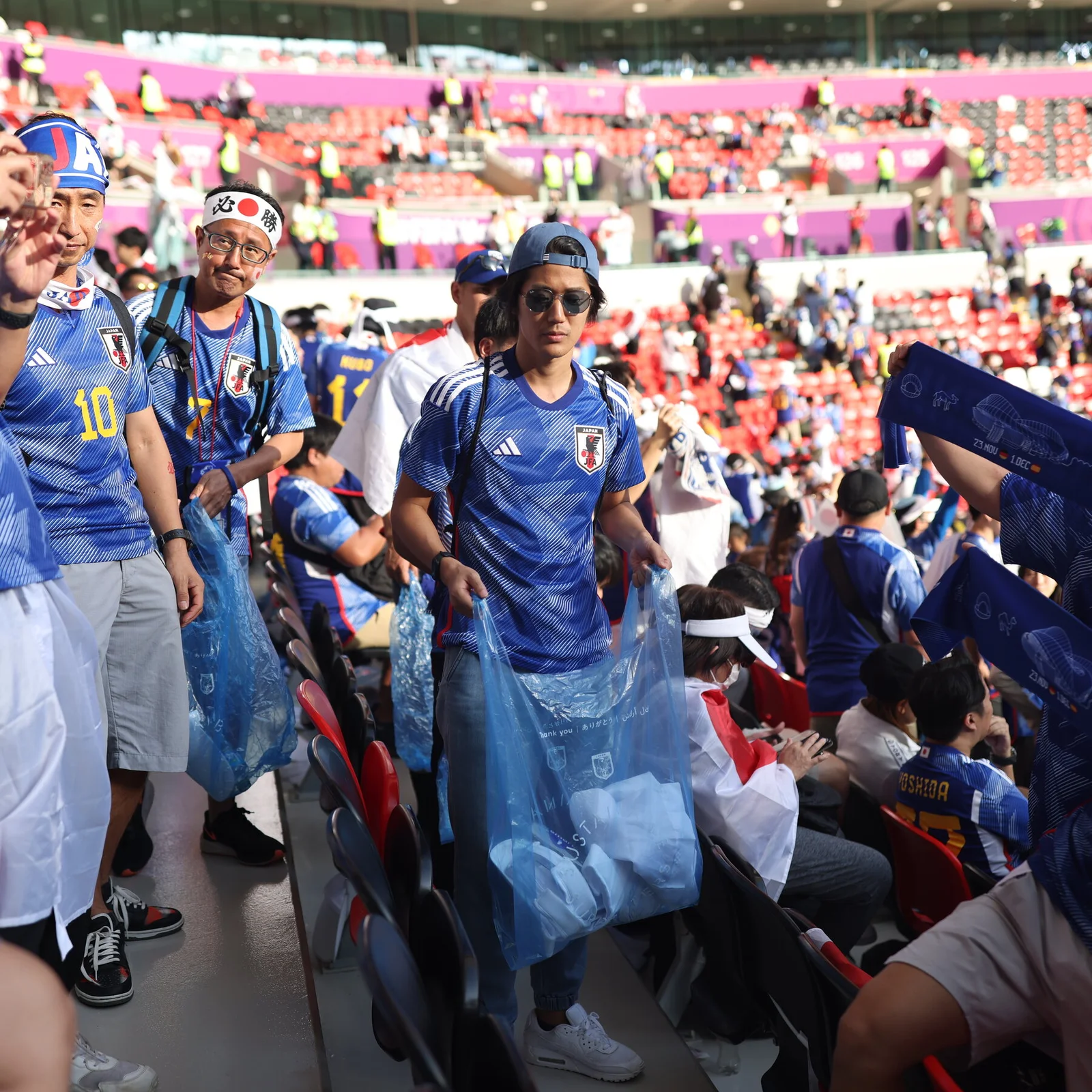 Japanese Fans cleaning the stadium after the match